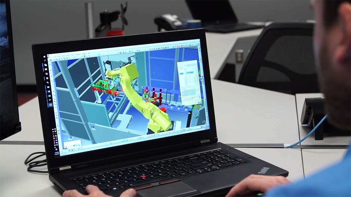 Virtual representation of robotic welding system on laptop screen